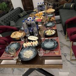The table laden with food with soups and main courses still to be served