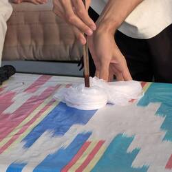 Preparing a simple silk scarf for batik by twisting it ..