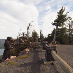 Edge of the parking lot and trees on more craggs