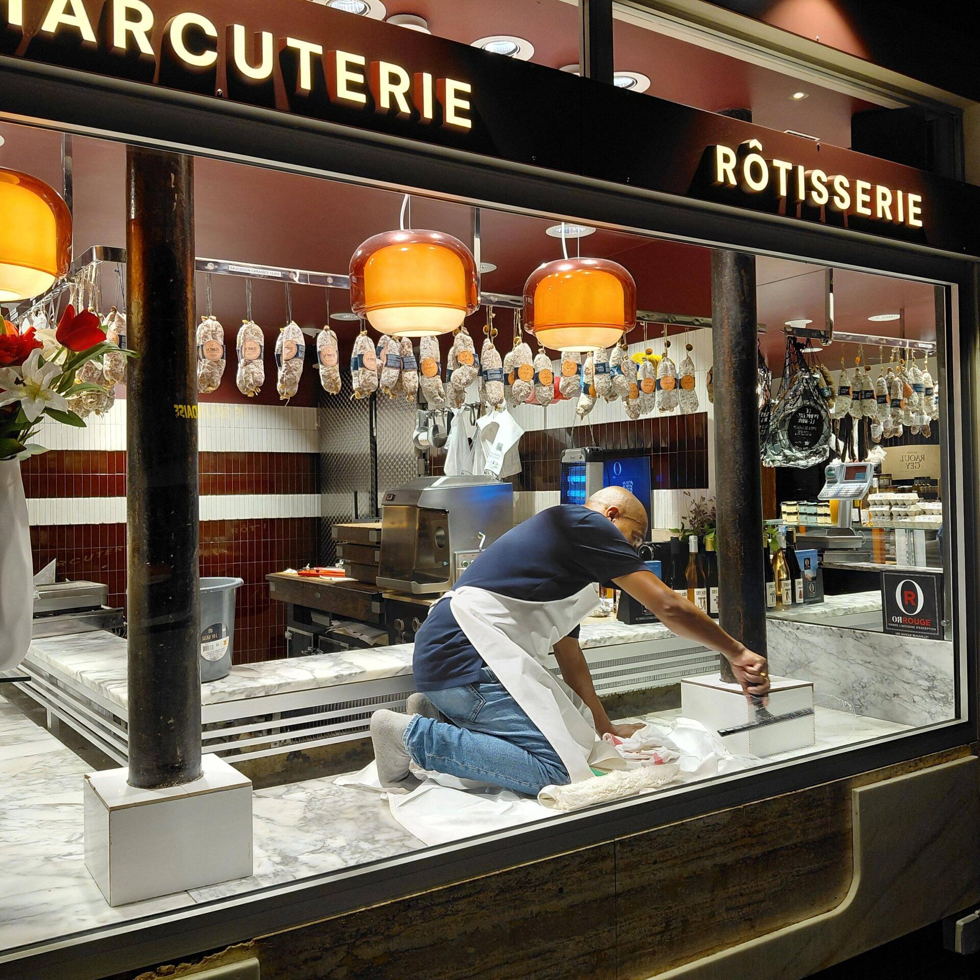 The butchers work is never done. Cleaning the windows, after shutting up shop, about 9pm