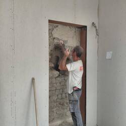 The stone wall is removed carefully by hand