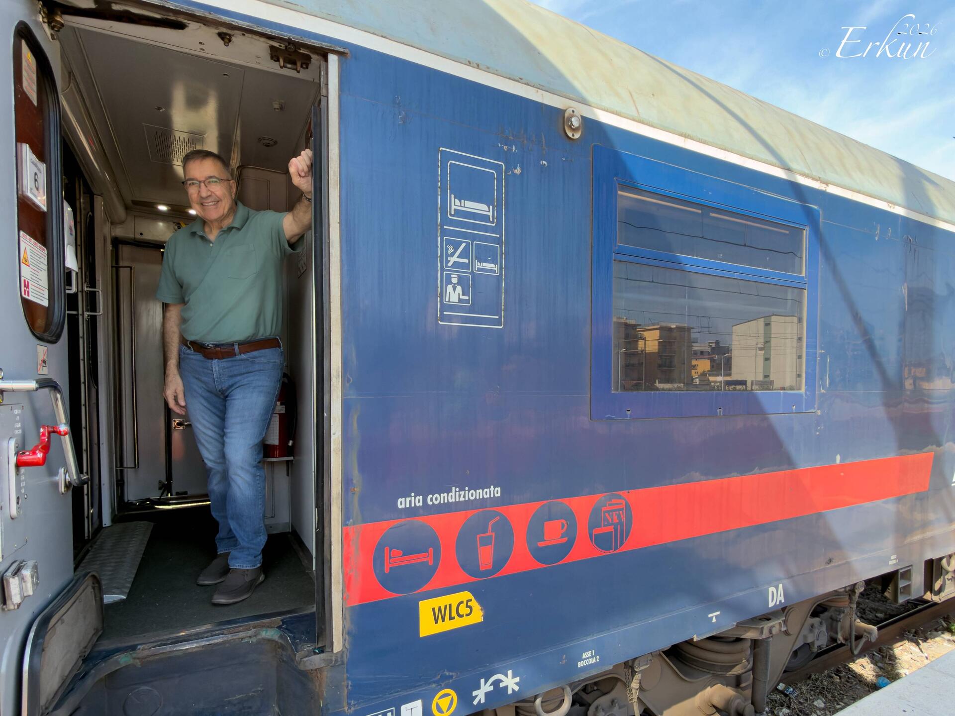 Getting some fresh air at the door of our sleeper car — Villa San Giovanni Station.