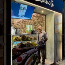 Mui's getting himself a cannolo from the Cannoli shop — Cefalù, Sicily.