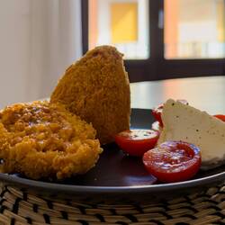 In eastern Sicily, arancini is cone-shaped (symbolizing Mount Etna) ... traditional ragù filling.