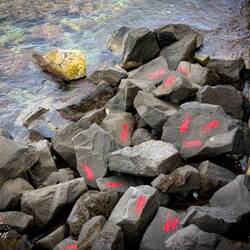 These humanoid stencils are an art installation that has become a signature of the rocky beachfront.