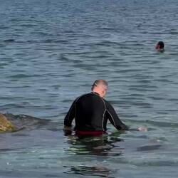 Taking a dip at Cala Rossa Beach ... let's hope the slippers don't go for a swim, too!