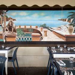 Mural of historic Ortigia Island perimeter at a restaurant on Lungomare Alfeo.