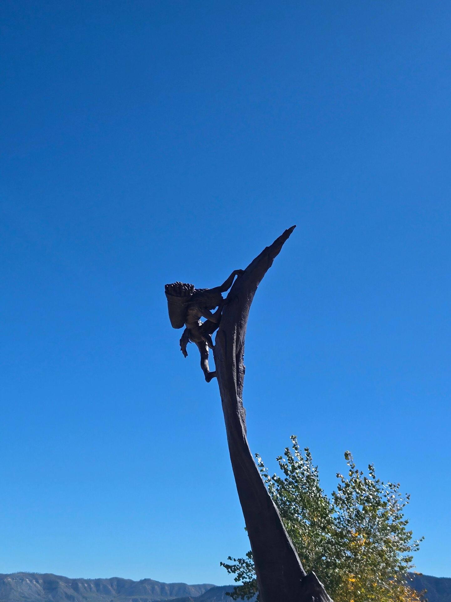 A sculpture representing the "ancient ones" who would have to climb into their homes carrying goods.