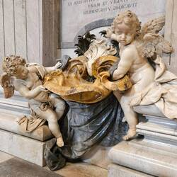 Two cherubs holding the holy water stoup