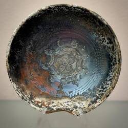 Greek black-glazed pottery bowl with stamped rosette pattern.