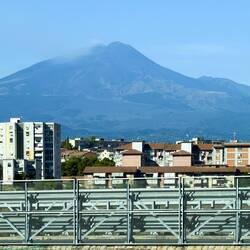 Mount Etna, spewing smoke, as our Trenitalia bus approaches Catania, Sicily.