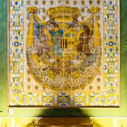 What remains of the original majolica tile flooring; full blazon of the family & flour-de-lis motif.