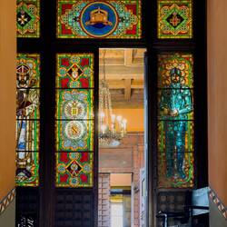 Stained glass coat of arms; St Dacius (L) & St Leo (patron saints of the Alliata family).
