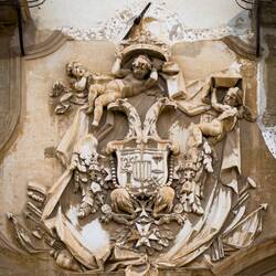 Decorative coat of arms on the exterior of Palazzo Alliata di Villafranca.