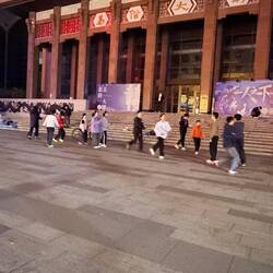 Kids playing jump rope in the square - no adults around.